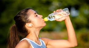 Coureuse en train de boire une bouteille d'eau
